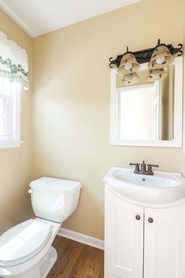 416 E Bauer Rd, Naperville, IL 60563 - half bathroom featuring wood finished floors, toilet, vanity, and baseboards