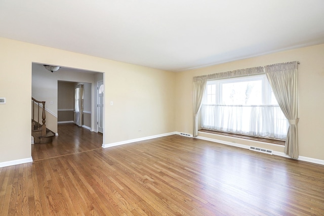 416 E Bauer Rd, Naperville, IL 60563 - unfurnished room featuring visible vents, stairway, wood finished floors, and baseboards