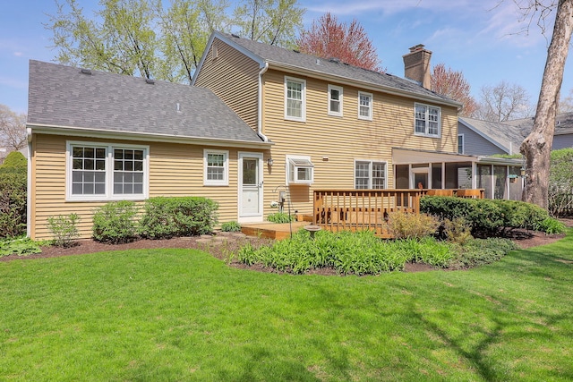 416 E Bauer Rd, Naperville, IL 60563 - rear view of property with a chimney, a wooden deck, a sunroom, roof with shingles, and a lawn