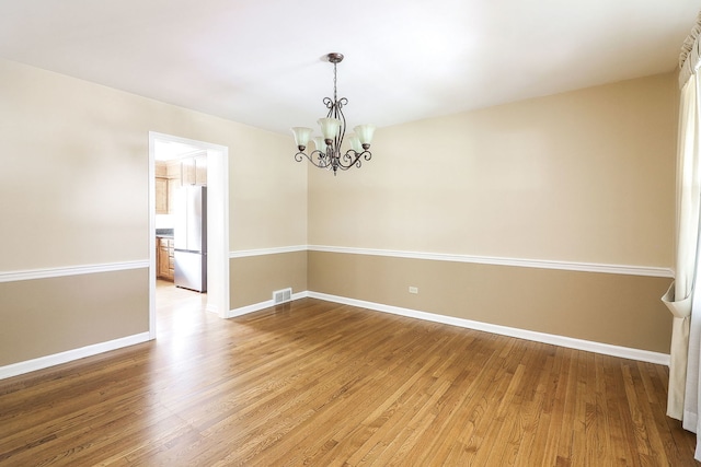 416 E Bauer Rd, Naperville, IL 60563 - empty room with visible vents, light wood-style floors, a chandelier, and baseboards