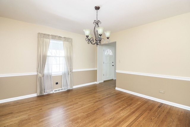 416 E Bauer Rd, Naperville, IL 60563 - unfurnished room with a chandelier, baseboards, and light wood-type flooring