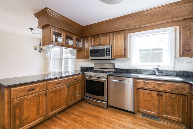 416 E Bauer Rd, Naperville, IL 60563 - kitchen featuring wood finished floors, stainless steel appliances, a sink, visible vents, and a peninsula