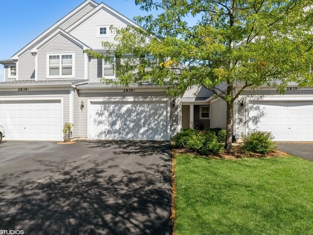 2835 Cattail Ct Unit B, Wauconda, IL 60084 - view of front facade featuring asphalt driveway, a front lawn, and a garage