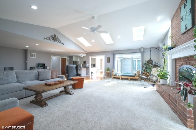 1485 Lexington Rd, Green Oaks, IL 60048 - carpeted living area with vaulted ceiling, a skylight, a brick fireplace, recessed lighting, and a ceiling fan
