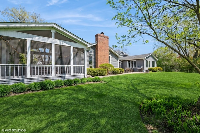 1485 Lexington Rd, Green Oaks, IL 60048 - rear view of house featuring a sunroom, a yard, and a chimney
