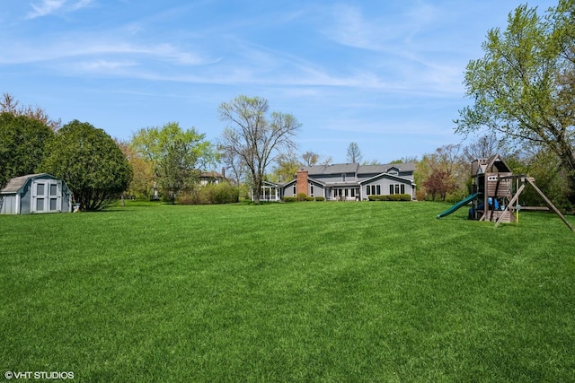 1485 Lexington Rd, Green Oaks, IL 60048 - view of grassy yard with a playground, a storage unit, and an outdoor structure