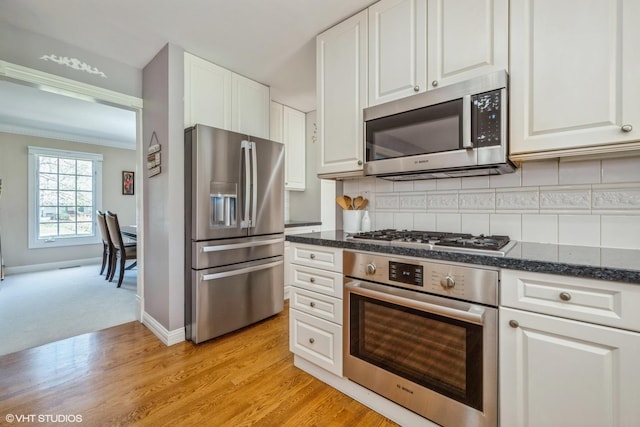 1485 Lexington Rd, Green Oaks, IL 60048 - kitchen with stainless steel appliances, white cabinetry, backsplash, light wood finished floors, and ornamental molding