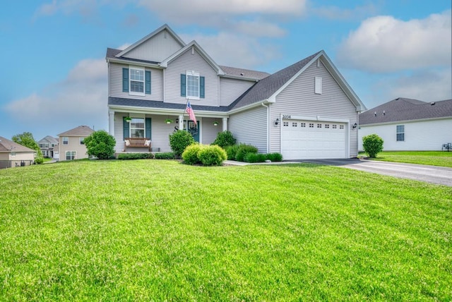 2034 Ingemunson Ln, Yorkville, IL 60560 - traditional-style house with driveway, an attached garage, a front lawn, and covered porch