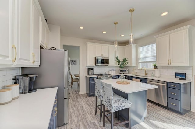 2034 Ingemunson Ln, Yorkville, IL 60560 - kitchen featuring appliances with stainless steel finishes, a sink, tasteful backsplash, white cabinets, and recessed lighting