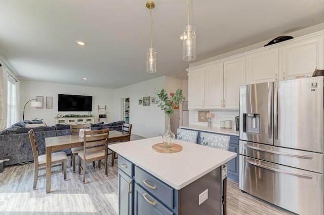 2034 Ingemunson Ln, Yorkville, IL 60560 - kitchen with stainless steel fridge with ice dispenser, white cabinetry, a kitchen island, light countertops, and recessed lighting