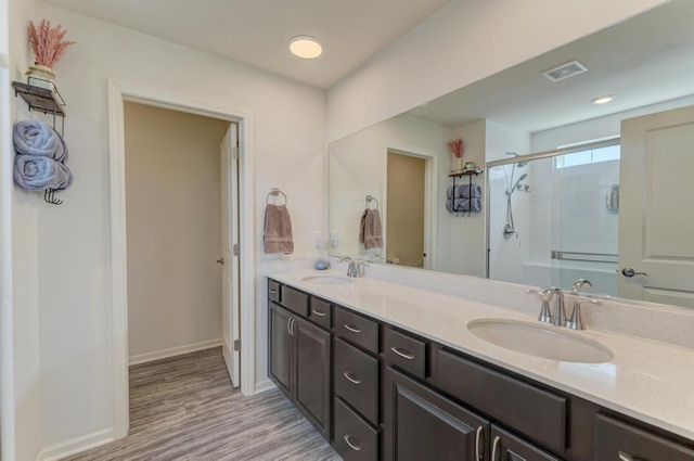 2034 Ingemunson Ln, Yorkville, IL 60560 - full bathroom with a stall shower, double vanity, wood finished floors, and baseboards