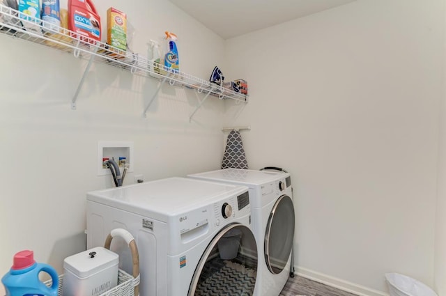 2034 Ingemunson Ln, Yorkville, IL 60560 - laundry room featuring baseboards, washer and dryer, and light wood-type flooring