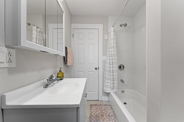 full bathroom featuring shower / bathtub combination with curtain and vanity