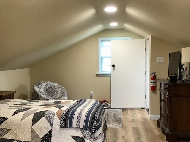 bedroom featuring vaulted ceiling and light wood finished floors