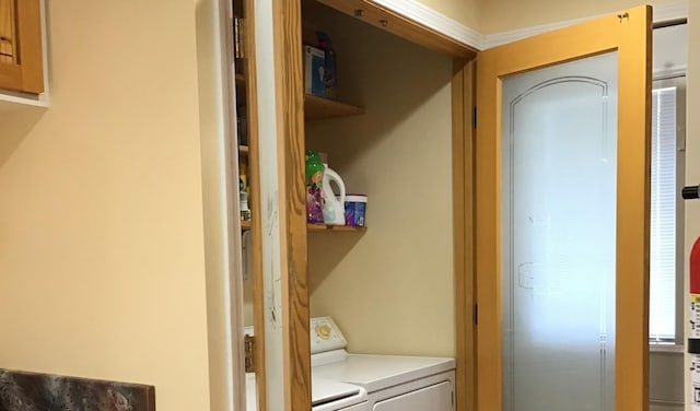 clothes washing area with separate washer and dryer and laundry area