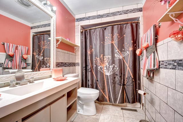 bathroom with tile patterned flooring, toilet, vanity, tile walls, and crown molding