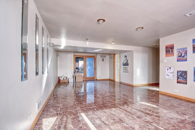 unfurnished room featuring baseboards, visible vents, and marble finish floor