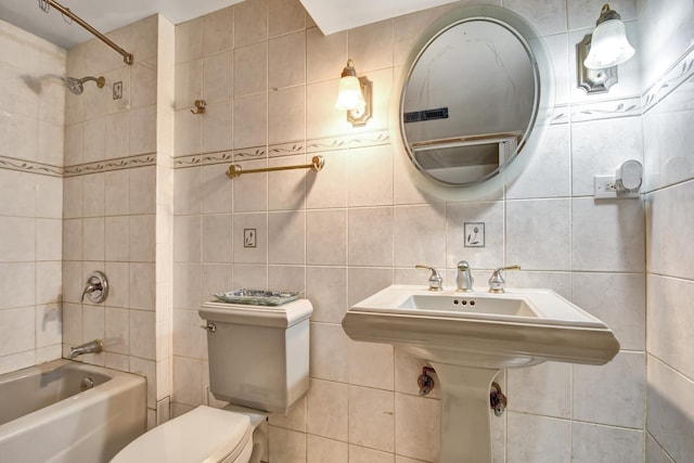 bathroom with backsplash, tub / shower combination, tile walls, and toilet