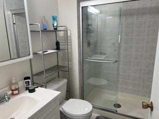 113 E Winchester Rd Unit C, Libertyville, IL 60048 - bathroom featuring vanity, toilet, and a stall shower