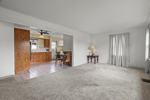 6449 W 84th St, Burbank, IL 60459 - living room featuring light carpet, light tile patterned floors, and ceiling fan