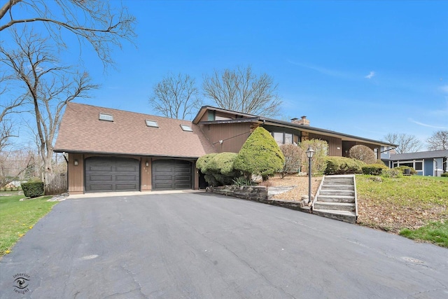 145 Markev Ln, New Lenox, IL 60451 - view of front facade featuring an attached garage, a chimney, and aphalt driveway