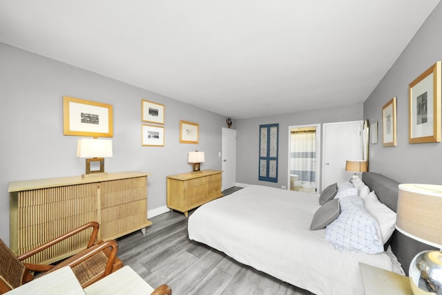 bedroom featuring baseboards and wood finished floors