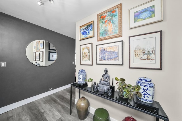 interior space featuring baseboards and wood finished floors