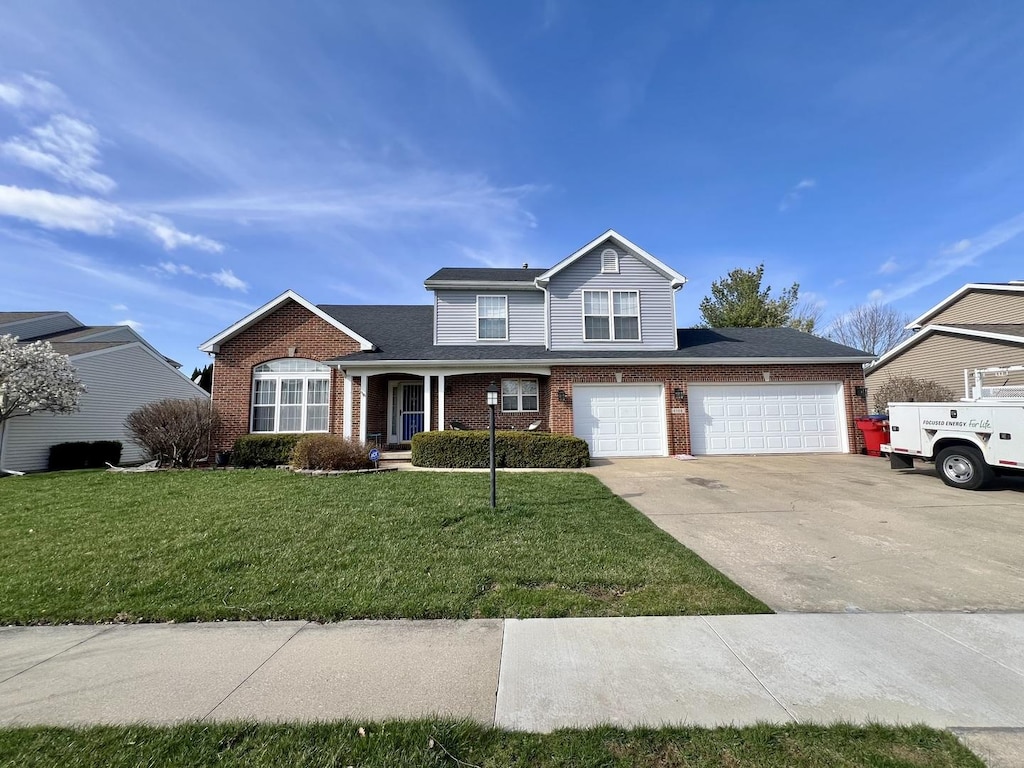 4508 Copper Ridge Rd, Champaign, IL 61822 - traditional home with an attached garage, driveway, a front lawn, and brick siding