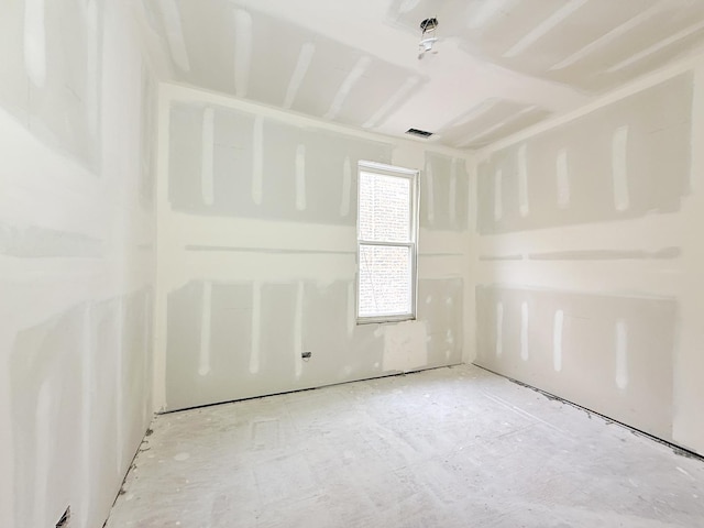 unfurnished room featuring visible vents