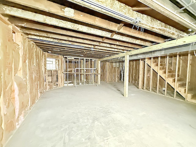 basement featuring stairs
