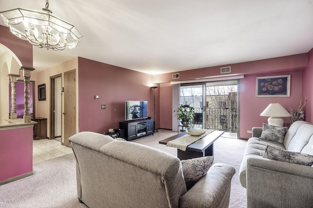 6430 W Belle Plaine Ave Unit 508, Chicago, IL 60634 - living room with arched walkways, visible vents, an inviting chandelier, and light carpet