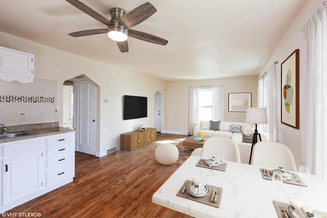 16224 Kedzie Ave, Markham, IL 60428 - living area with arched walkways, dark wood-style floors, and a ceiling fan