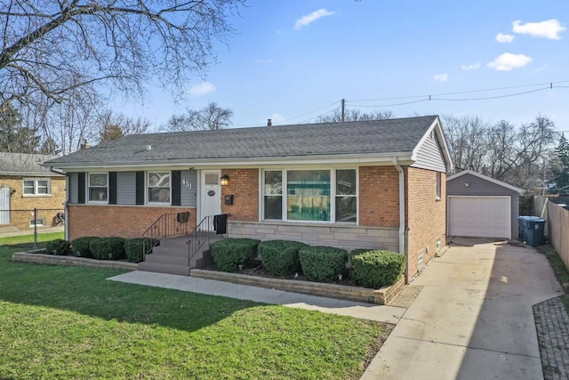 view of front of property with a front yard, fence, an outdoor structure, brick siding, and driveway