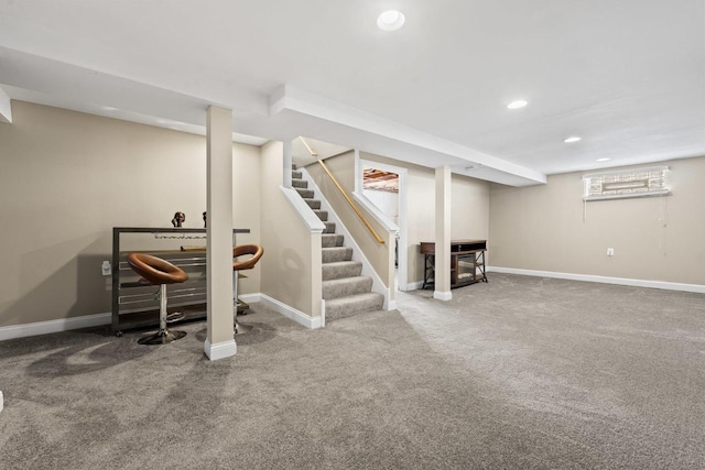 below grade area featuring stairway, recessed lighting, carpet flooring, and baseboards