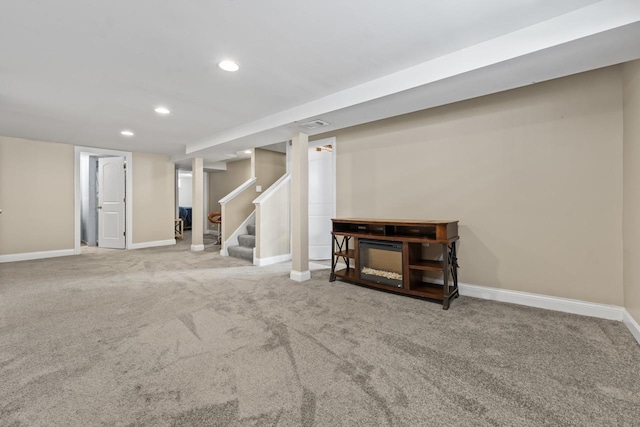 finished below grade area with baseboards, stairway, carpet flooring, and recessed lighting