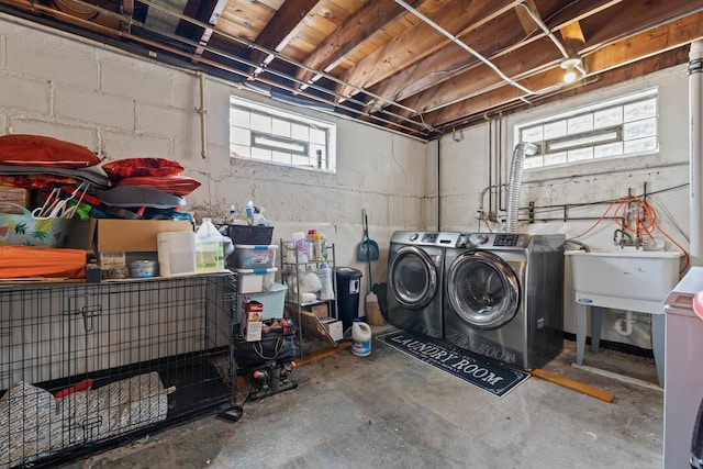 basement with a sink and washing machine and dryer