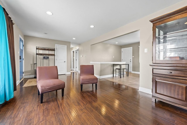 living area featuring wood finished floors, baseboards, and recessed lighting