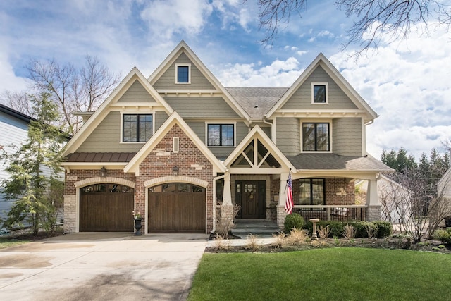 4529 Washington St, Downers Grove, IL 60515 - view of front of house with concrete driveway, a front lawn, brick siding, a garage, and covered porch