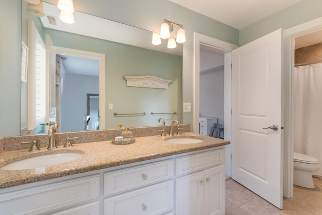 4529 Washington St, Downers Grove, IL 60515 - bathroom featuring a sink, toilet, double vanity, and tile patterned flooring
