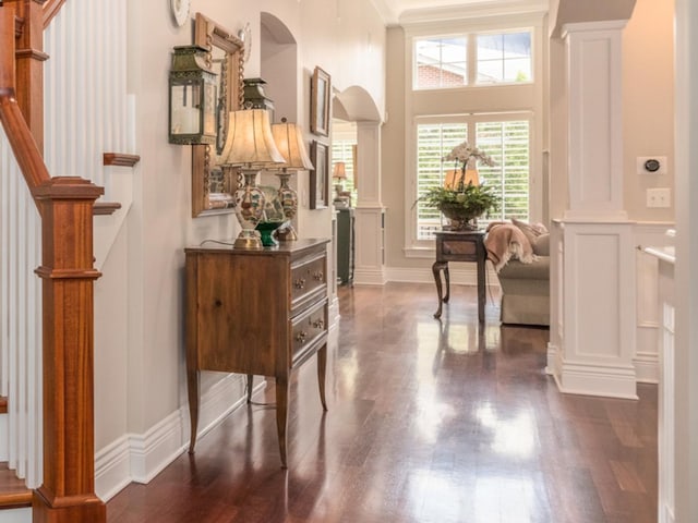4529 Washington St, Downers Grove, IL 60515 - entryway with baseboards, dark wood-style floors, stairs, ornate columns, and arched walkways