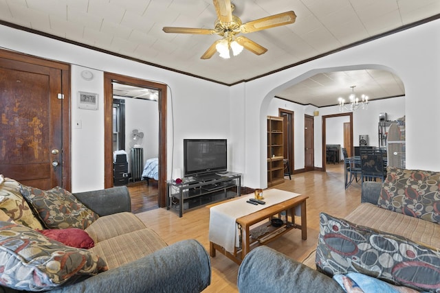 1913 N Kildare Ave, Chicago, IL 60639 - living area featuring arched walkways, ceiling fan with notable chandelier, light wood-style floors, and crown molding