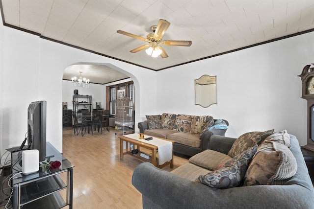 1913 N Kildare Ave, Chicago, IL 60639 - living room featuring arched walkways, ornamental molding, light wood-type flooring, and ceiling fan with notable chandelier