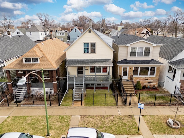 1913 N Kildare Ave, Chicago, IL 60639 - view of front of house featuring a residential view, a front yard, a fenced front yard, and a shingled roof