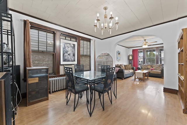1913 N Kildare Ave, Chicago, IL 60639 - dining space featuring ornamental molding, light wood-style floors, radiator, and arched walkways