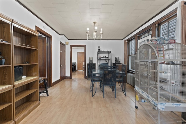 1913 N Kildare Ave, Chicago, IL 60639 - dining room with baseboards, a chandelier, and light wood-type flooring