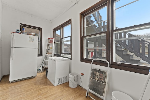 1913 N Kildare Ave, Chicago, IL 60639 - laundry area with heating unit and light wood-style flooring