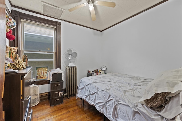 1913 N Kildare Ave, Chicago, IL 60639 - bedroom featuring visible vents, ornamental molding, radiator heating unit, a ceiling fan, and wood-type flooring