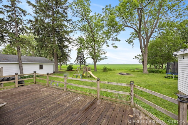 301 S Shabbona Rd, Shabbona, IL 60550 - wooden deck with a trampoline, a playground, a lawn, an outdoor fire pit, and a view of rural / pastoral area