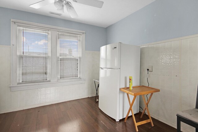 18241 Roy St, Lansing, IL 60438 - kitchen with freestanding refrigerator, dark wood finished floors, a ceiling fan, a wainscoted wall, and tile walls