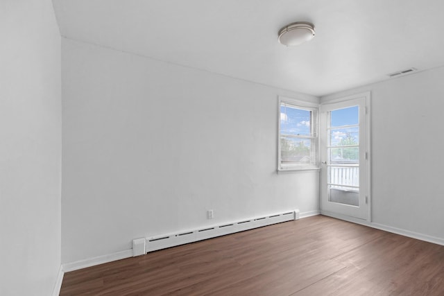 18241 Roy St, Lansing, IL 60438 - empty room featuring baseboard heating, wood finished floors, and baseboards